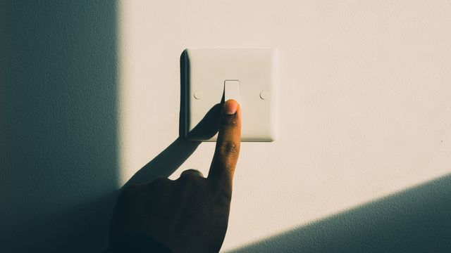 Finger pressing a light switch, symbolizing the activation of switch-like genes.